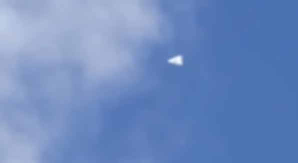 In Amsterdam, a triangular UFO hovered in the sky and suddenly flew away at high speed