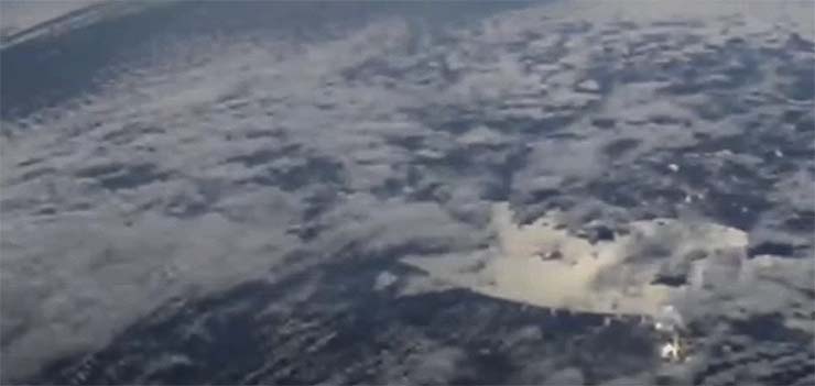 The International Space Station captures a huge alien spacecraft hidden in the clouds