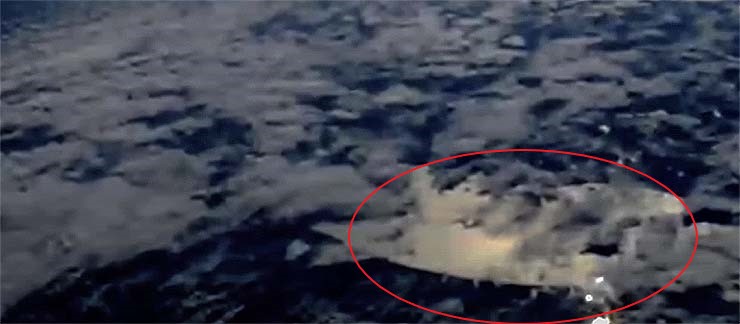 The International Space Station captures a huge alien spacecraft hidden in the clouds