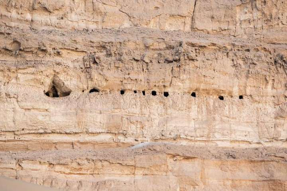 Ancient rock-cut chambers are found on a cliff in Abydos, Egypt