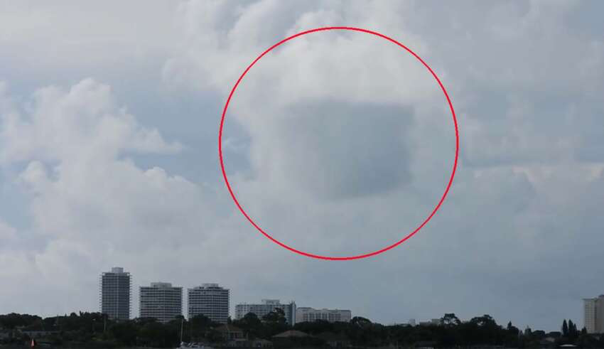 A photographer records a cube-shaped UFO hidden in clouds on a Florida beach
