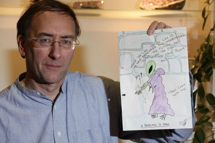 Simon Parkes With A Sketch Drawn By Him Portraying Alien