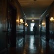 Haunting Victorian hotel corridor at night with ghostly figure near Room 217 — The Stanley Hotel paranormal investigation 2026